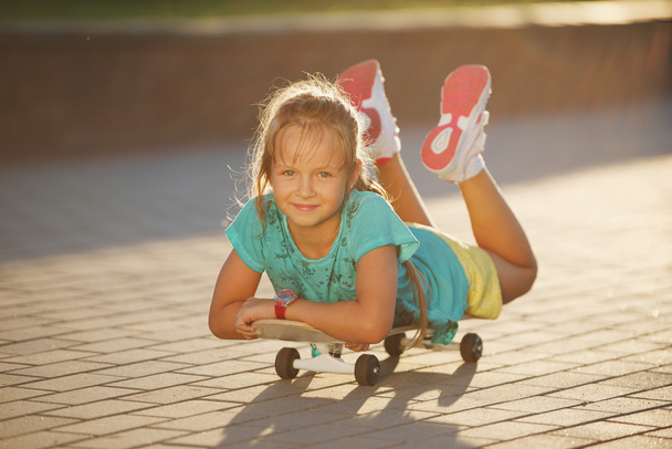 cute little girl with skateboard outdoors - Photo, Image