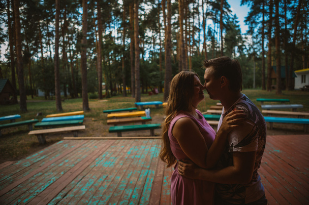 Romantic young couple kissing on background summer forest - Фото, зображення