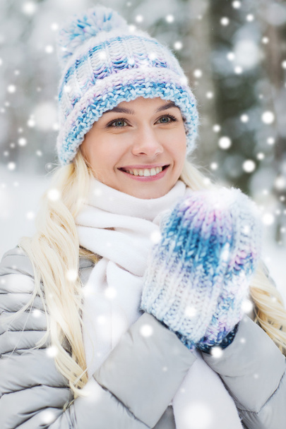 smiling young woman in winter forest - Fotoğraf, Görsel