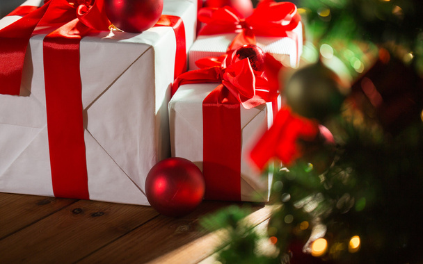 gift boxes and red balls under christmas tree - Φωτογραφία, εικόνα