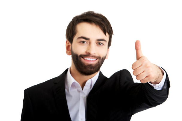 Happy businessman with thumbs up gesture. - Foto, afbeelding