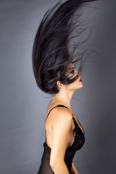 Portrait of a beautiful brunette woman posing in sexy black ling - Фото, зображення