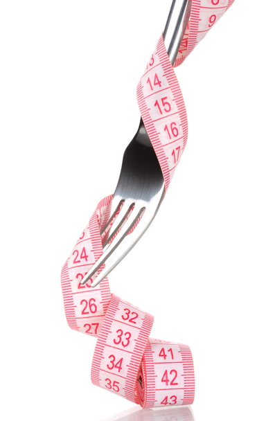 Fork and measuring tape isolated on white - Foto, afbeelding