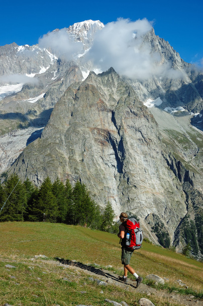 Trekker walking along a mountain path - Фото, зображення