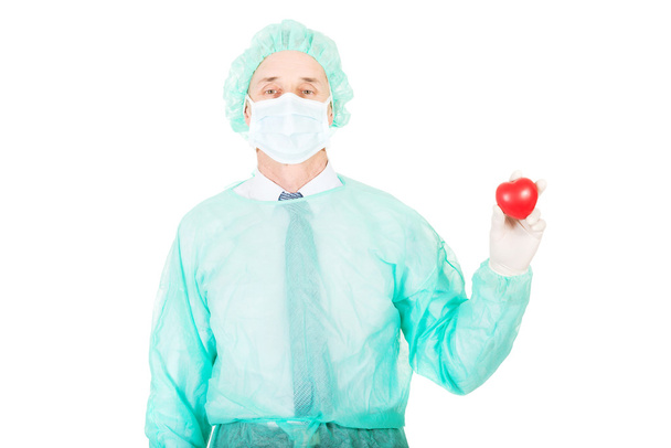 Male doctor holding heart model - Фото, изображение