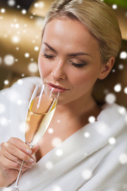 beautiful young woman drinking champagne at spa - Foto, imagen