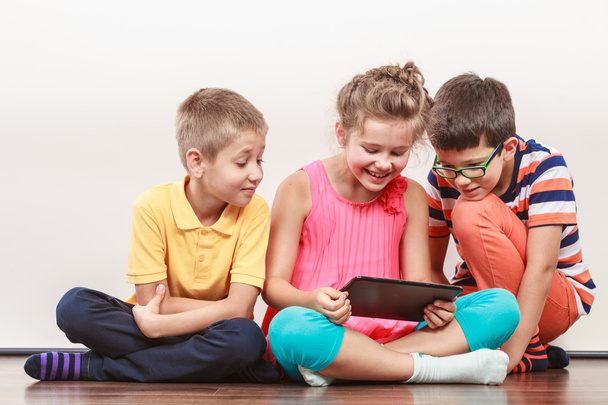 Kids playing on tablet. - 写真・画像