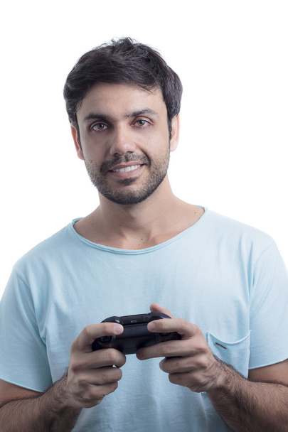 Young man playing video game with wireless joystick - Zdjęcie, obraz