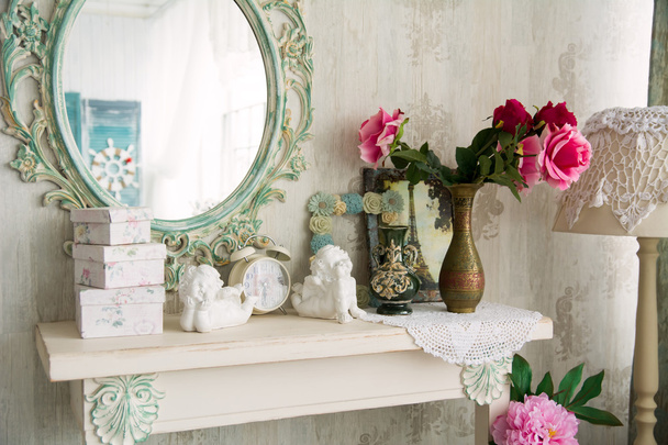 Closeup vintage interior with mirror and a table with a vase and - Photo, Image