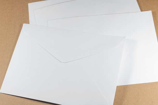 Nepoužité bílé obálky na hnědé pozadí - Fotografie, Obrázek