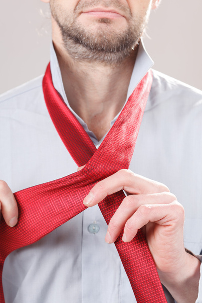Man adjusting tie - Φωτογραφία, εικόνα