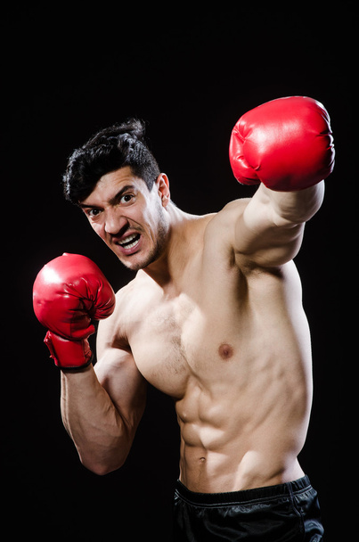Muscular man in boxing concept - 写真・画像
