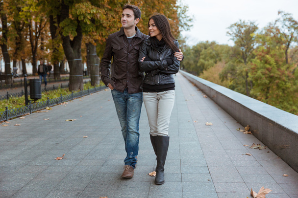 Couple walking in autumn park - Фото, зображення
