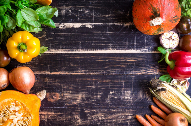 Fresh vegetables on a rustic dark textured table. Autumn backgro - Photo, Image
