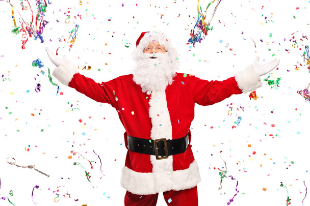 Santa Claus standing in a bunch of confetti - Photo, image