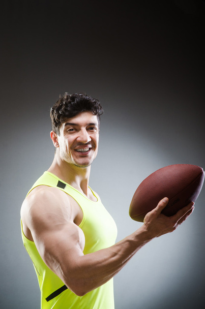 Muscular man with american football - Photo, Image