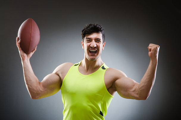 Muscular man with american football - Photo, image