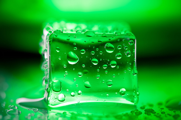 Colored ice cubes on wet glass table. Selective focus. Shallow d - Foto, imagen