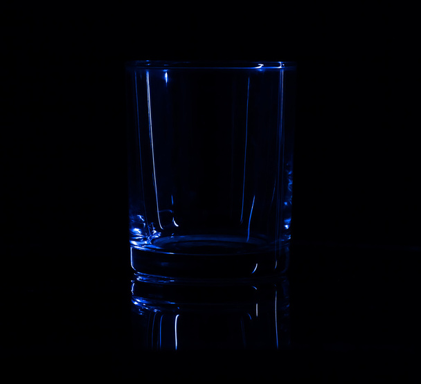 Silhouette of simple glass in the low-key lighting and surface r - 写真・画像