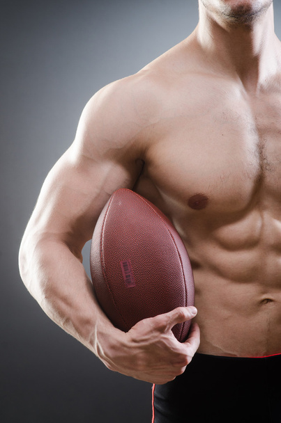 Muscular man with american football - Photo, image