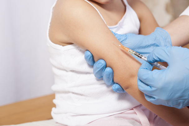 Een klein meisje vaccineren - Foto, afbeelding