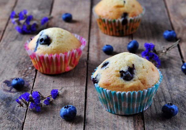 homemade cupcakes with berries and lavender on a wooden table, rustic style - Fotoğraf, Görsel
