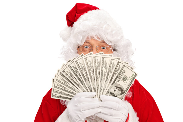 Santa Claus covering face with money - Foto, imagen