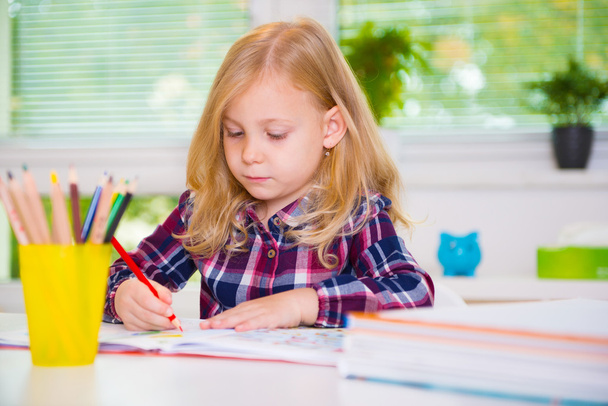 Cute girl drawing at school - Фото, изображение