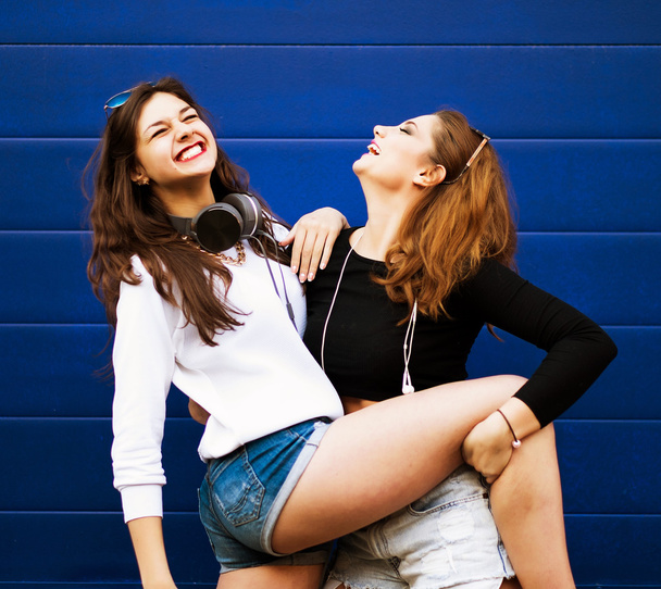Two young hipster girl friends together having fun. - Фото, изображение