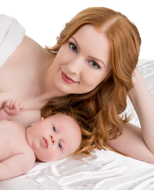 Cute redhead woman and her child posing at camera - Photo, image