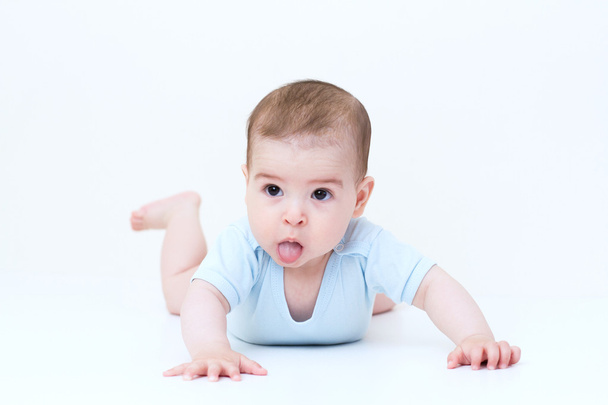 Beautiful baby look up with tongue - Foto, Imagen