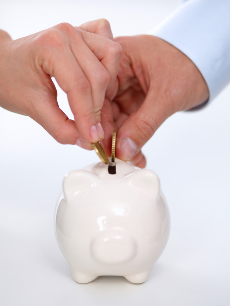 People putting coin into the piggy bank - Photo, Image
