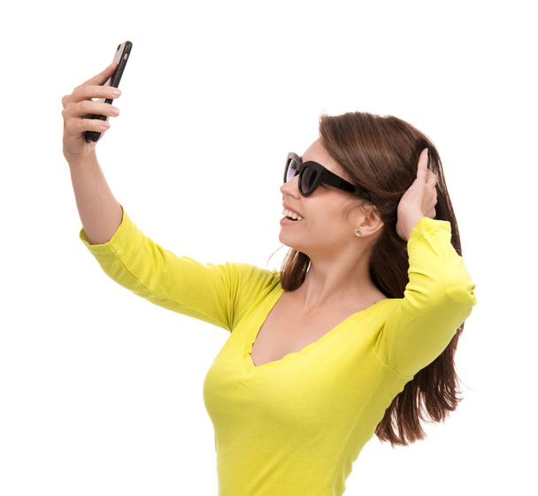 Young pretty girl in sunglasses make self portrait selfie with h - Foto, afbeelding