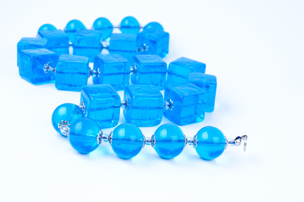 Blue glass beads on white background - Foto, Imagen