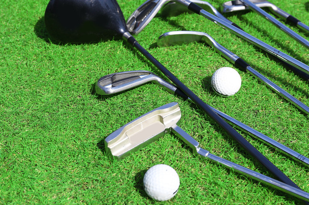 Different golf clubs  and balls on golf course - Foto, imagen