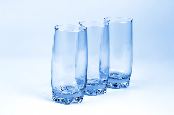 three blue transparent glass with a light blue background - Foto, Bild