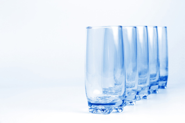 five blue transparent glass with a light blue background - Photo, Image