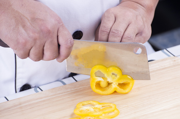 Chef cutting yellow bell pepper - Photo, Image
