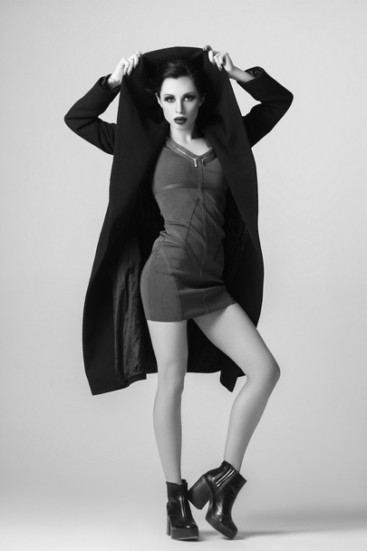 Beautiful sexy woman in a black coat for autumn winter fashion - Фото, изображение