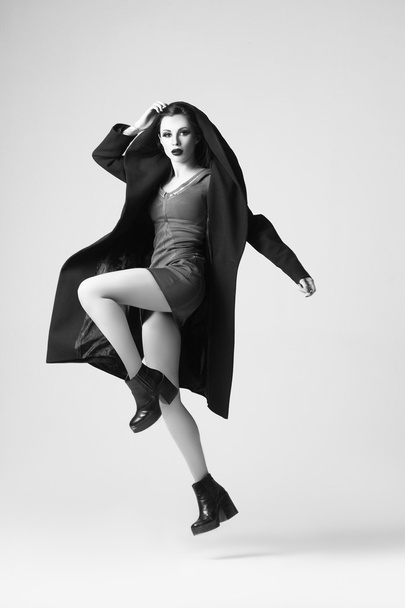 Beautiful sexy woman in a black coat for autumn winter fashion - 写真・画像