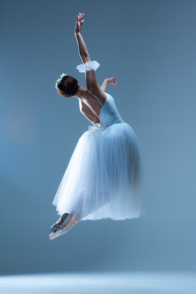 Portrait of the ballerina on blue background - Фото, зображення