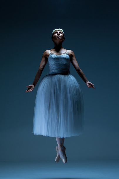 Portrait of the ballerina on blue background - Foto, afbeelding