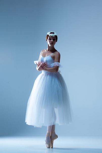 Portrait of the ballerina on blue background - Foto, imagen