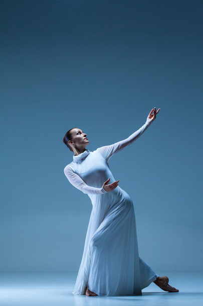 Portrait of the ballerina on blue background - Foto, Imagen