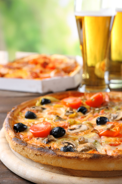 Pizza served with beer on wooden table - Fotografie, Obrázek