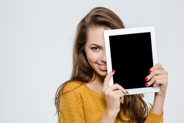 Woman covering half face with tablet computer - Foto, afbeelding