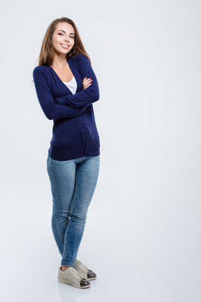 Happy woman standing with arms folded - Foto, imagen