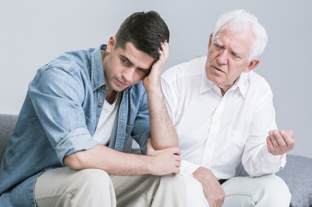 Troubled man talking with father - Photo, Image