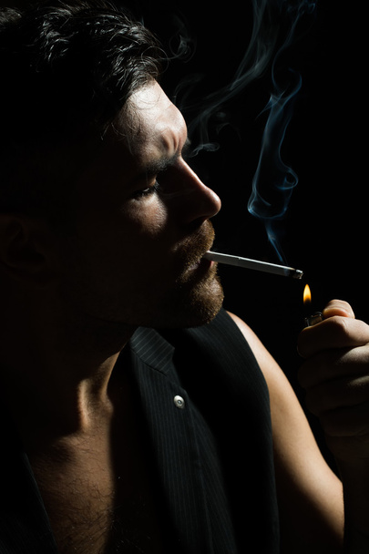 Bearded man lights up cigarette - Zdjęcie, obraz