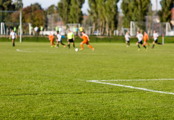 Blurred soccer players playing amateur soccer match - Fotografie, Obrázek
